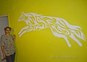 Wall painting of a tribal wolf with my mom next to it.